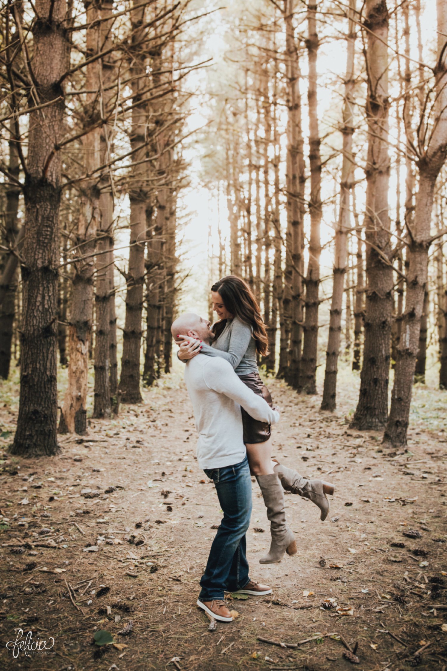images by feliciathephotographer.com | destination wedding photographer | family portraits | fall attire | autumn | woodland setting | forest | casual | jeans | corduroy | sparkly boots | fur vest | toddlers | hipster | playful | parents and kiddos | father mother | lumber | kiss | couple | 