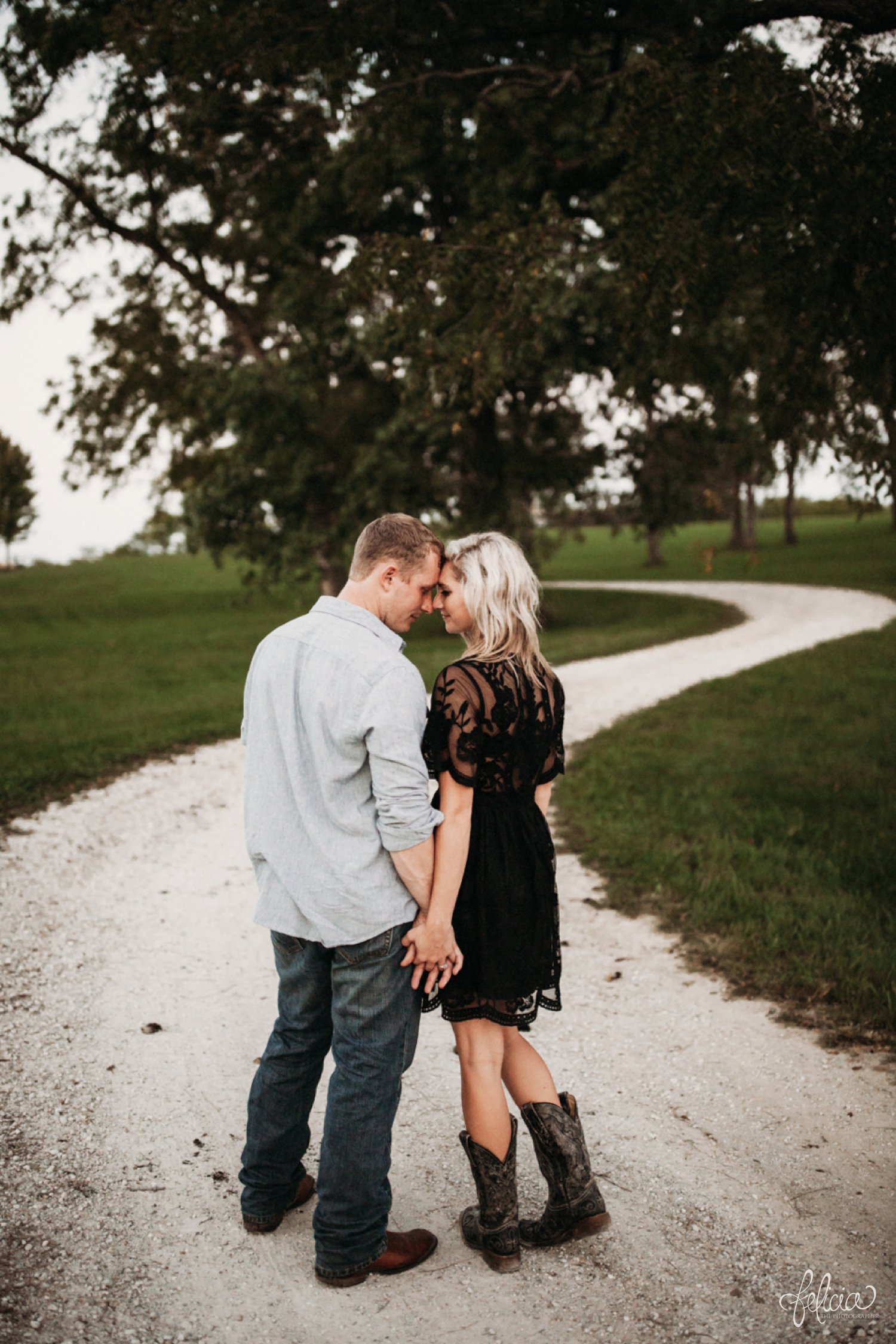 images by feliciathephotographer.com | destination wedding photographer | engagement | farmhouse | country | kansas city | sweet southern | black eyelet romper | unique halo diamond ring | casual | black boots | amazon | cowboy | red nails | nature | black and white | holding hands | gravel road | 
