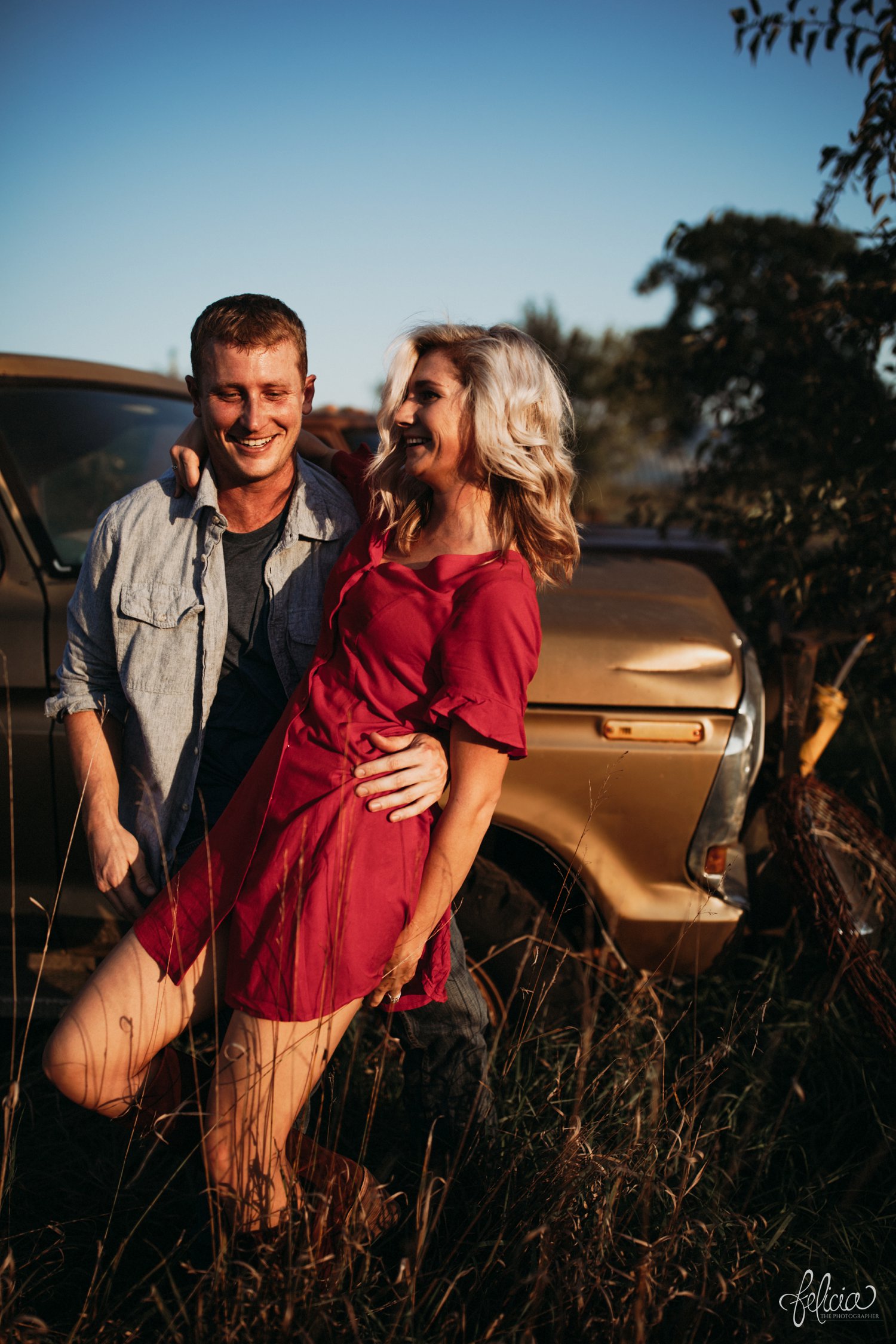 images by feliciathephotographer.com | destination wedding photographer | engagement | farmhouse | country | kansas city | sweet southern | red dress | nordstrom rack | unique halo diamond ring | casual | brown boots | amazon | cowboy | vintage truck | dirt road | golden hour | 
