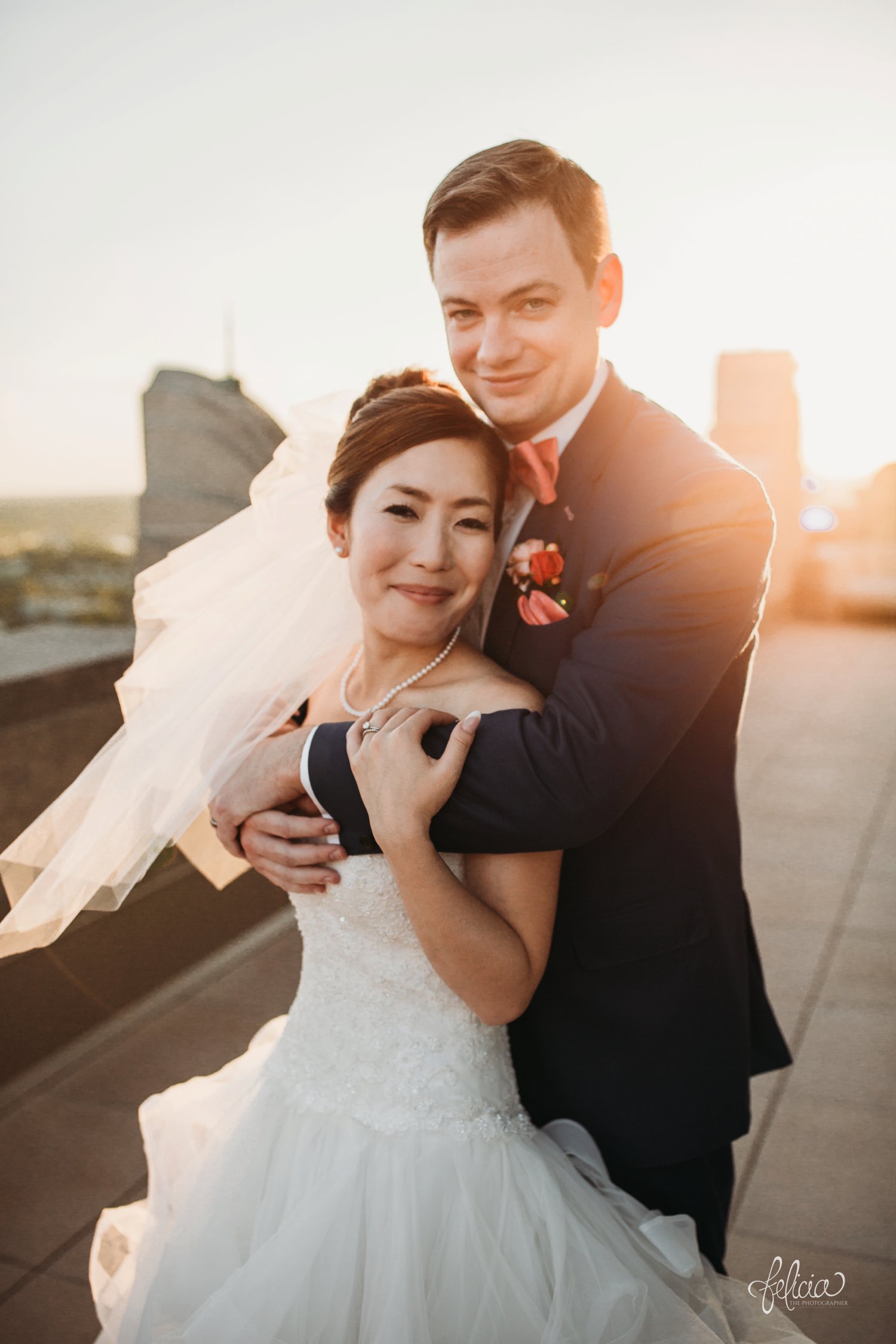 images by feliciathephotographer.com | destination wedding photographer | the grand hall at power and light | kansas city | missouri | downtown | glamorous | multicultural | sunset | golden hour | couple portraits | rooftop | romantic | natural light | pearl necklace | peach bow tie | 