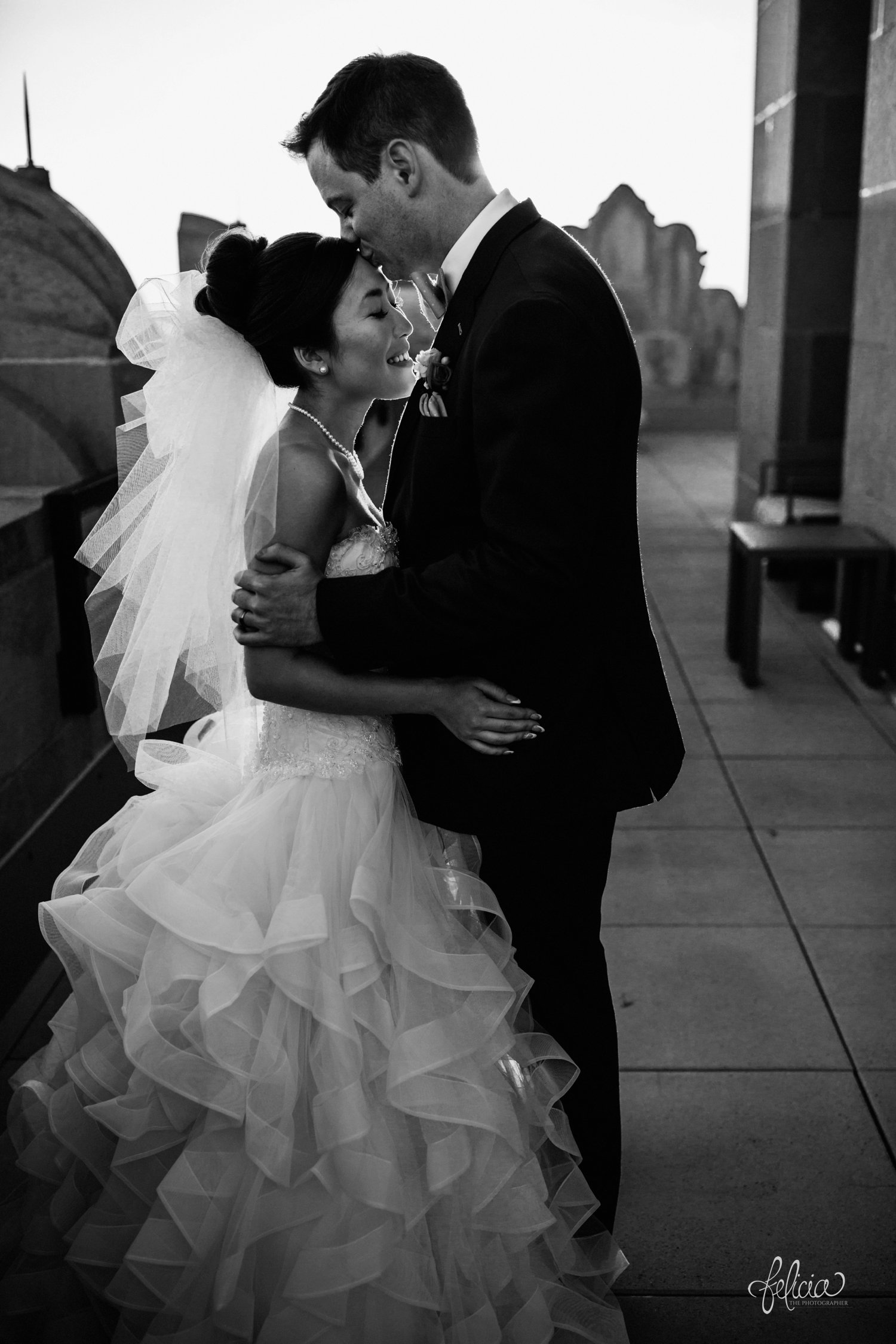 images by feliciathephotographer.com | destination wedding photographer | the grand hall at power and light | kansas city | missouri | downtown | glamorous | multicultural | sunset | golden hour | couple portraits | rooftop | romantic | natural light | pearl necklace | bow tie | black and white | 