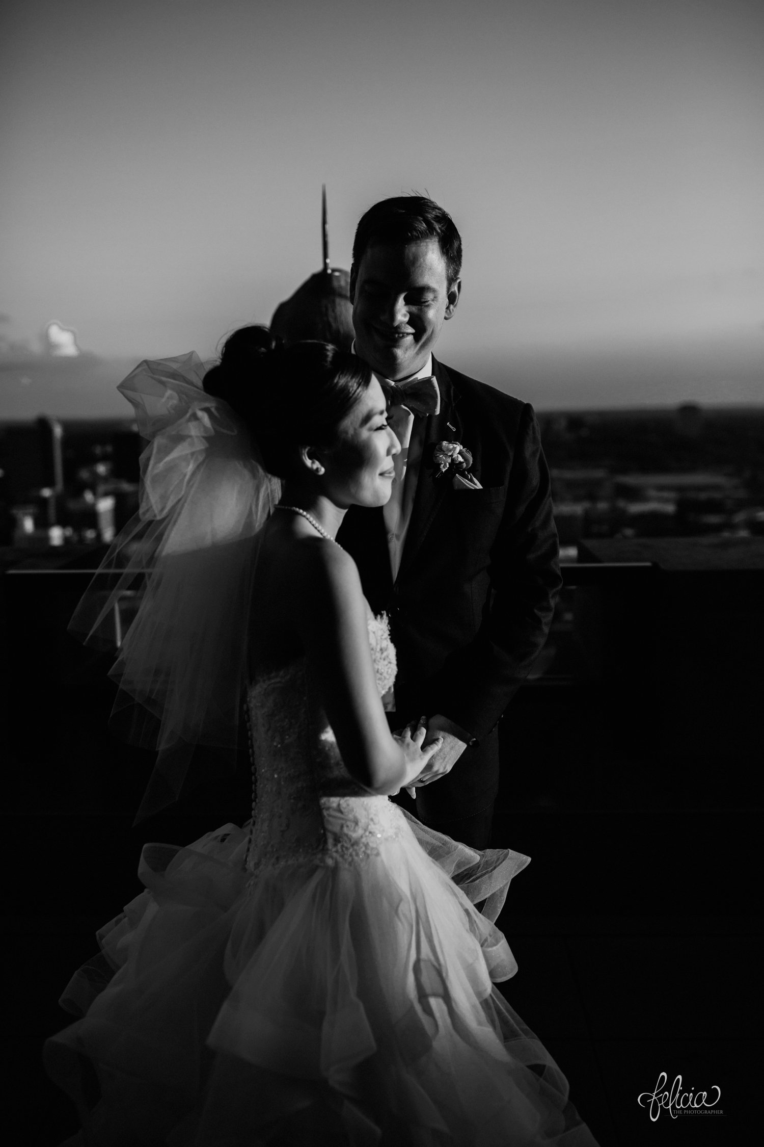 images by feliciathephotographer.com | destination wedding photographer | the grand hall at power and light | kansas city | missouri | downtown | glamorous | multicultural | black and white | couple portrait | dramatic lighting | sunset | golden hour | 