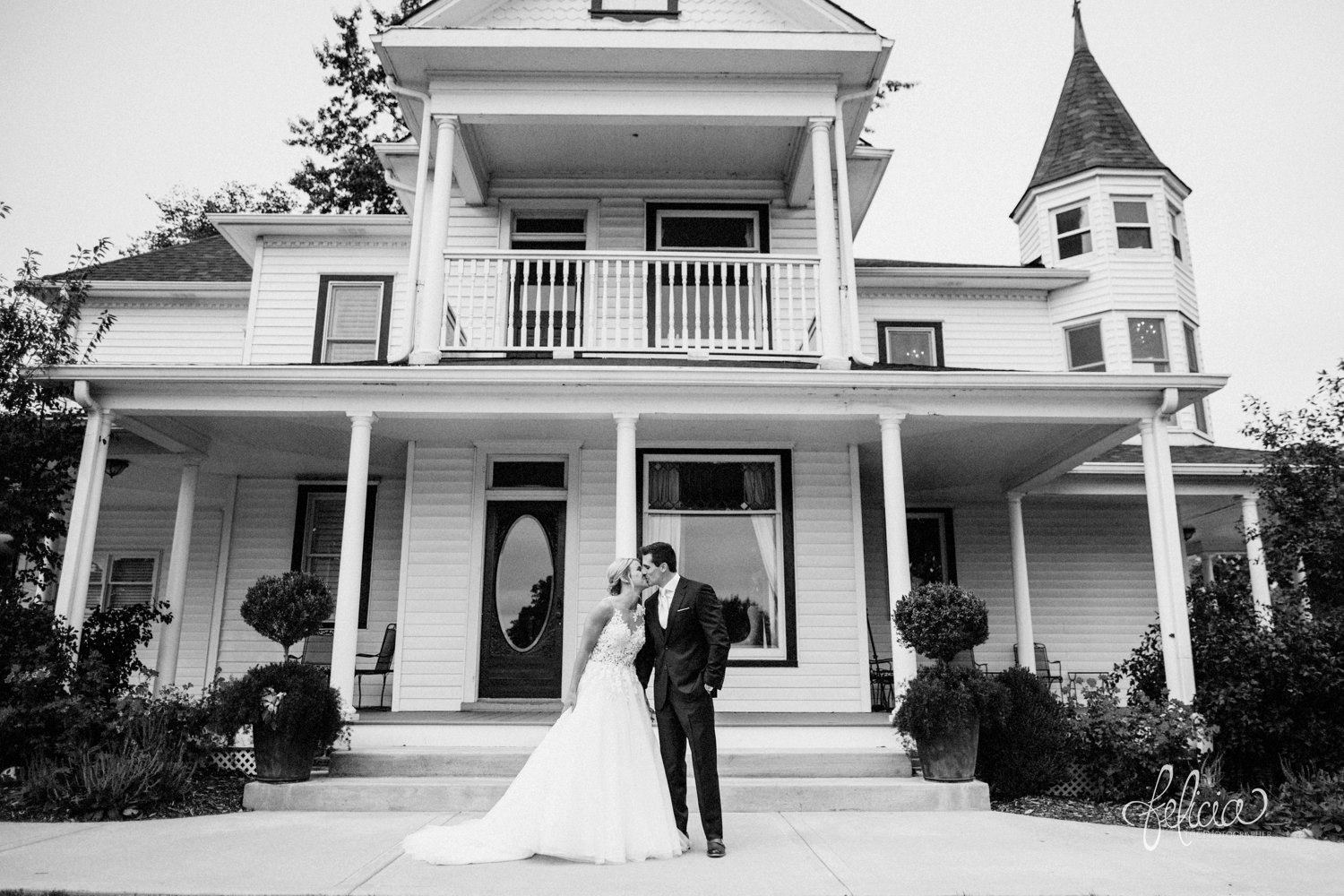 images by feliciathephotographer.com | destination wedding photographer | kansas city | eighteen ninety | classic | first look | pre ceremony | floral lace backed dress | bridal extraordinaire | pronovias | J. H. & sons clothier | navy suit | true love | black and white | kiss | 