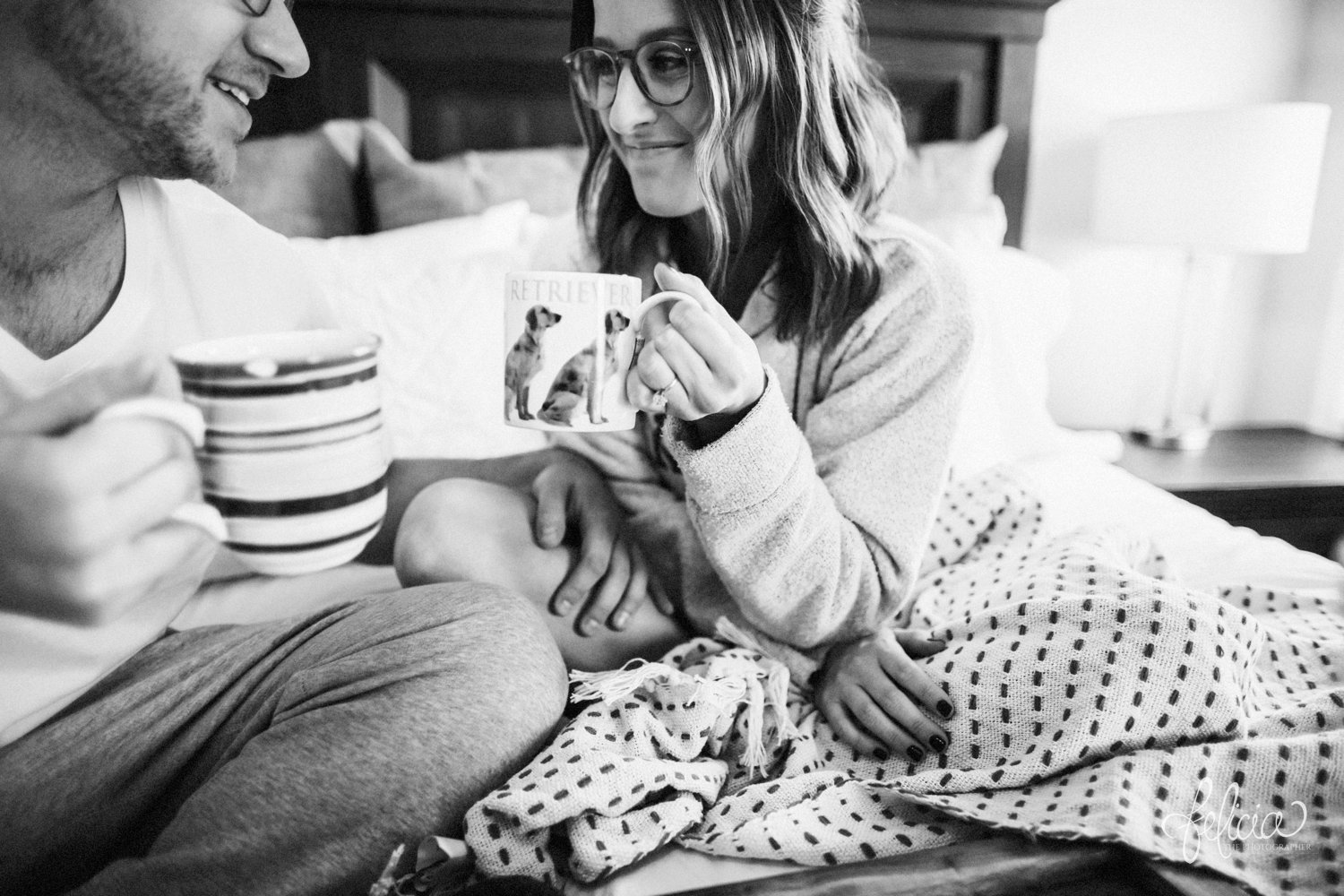 images by feliciathephotographer.com | destination photographer | engagement session | in home | lifestyle | kansas city | cozy | bed | snuggles | golden retriever | casual | fuzzy socks | laughter | jammies | kiss | black and white | 