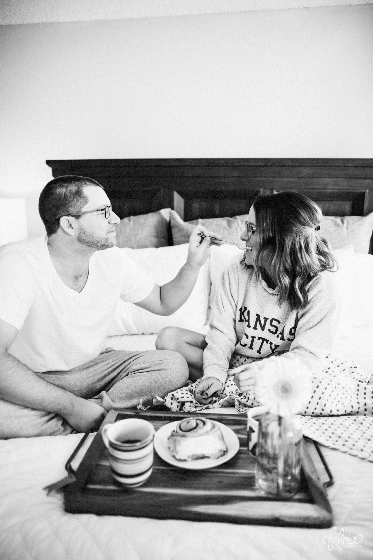 images by feliciathephotographer.com | destination photographer | engagement session | in home | lifestyle | kansas city | cozy | breakfast in bed | snuggles | golden retriever | casual | fuzzy socks | laughter | jammies | kiss | black and white | cinnamon bun | corner cafe | flower | coffee | 