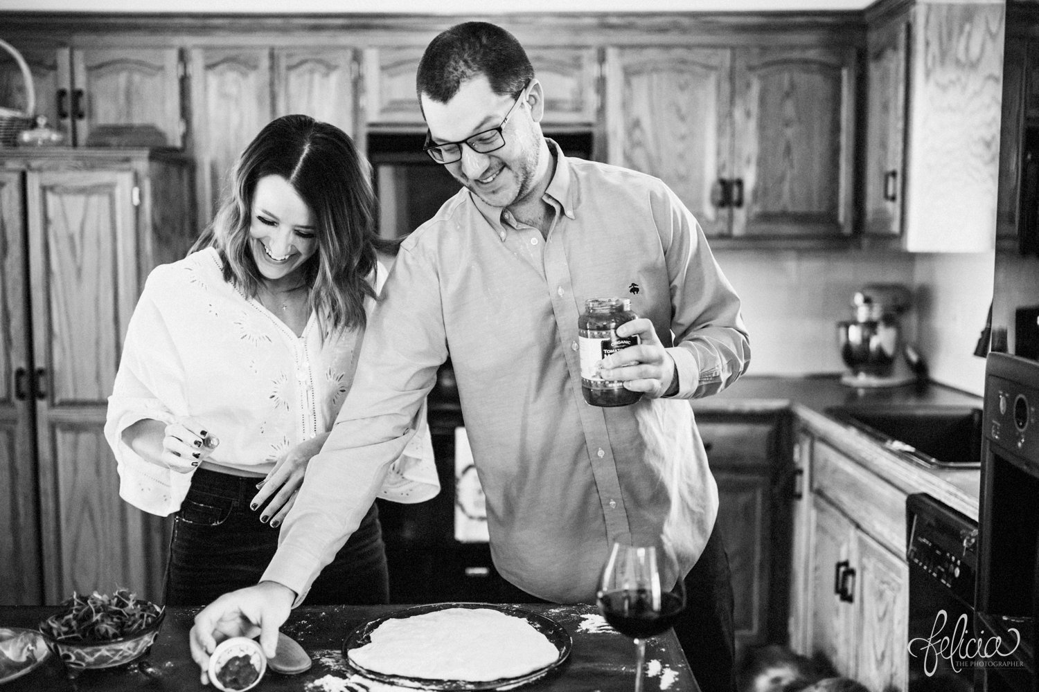 images by feliciathephotographer.com | destination photographer | engagement session | in home | lifestyle | kansas city | cooking from scratch | ingredients | crust | pizza | flour | details | romantic | black and white | silly | playful | 