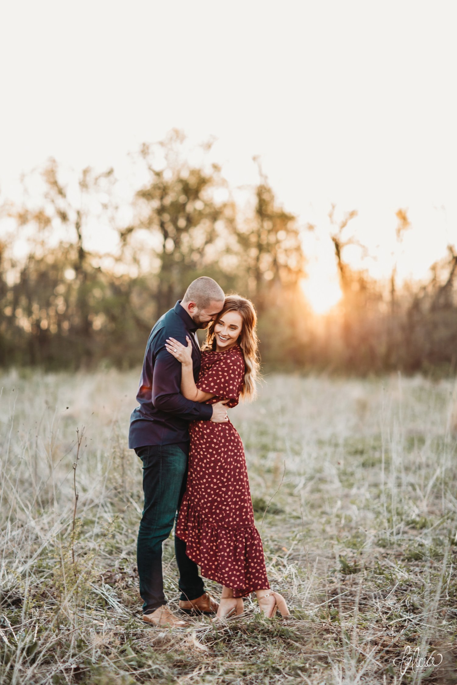 images by feliciathephotographer.com | Burr Oak Woods | engagement photos | wedding photographer | engagement photographer | field | sunrise | posed | posing | hug | laughter | love | smile | sunlight | red dress | blue jeans | polka dots | 