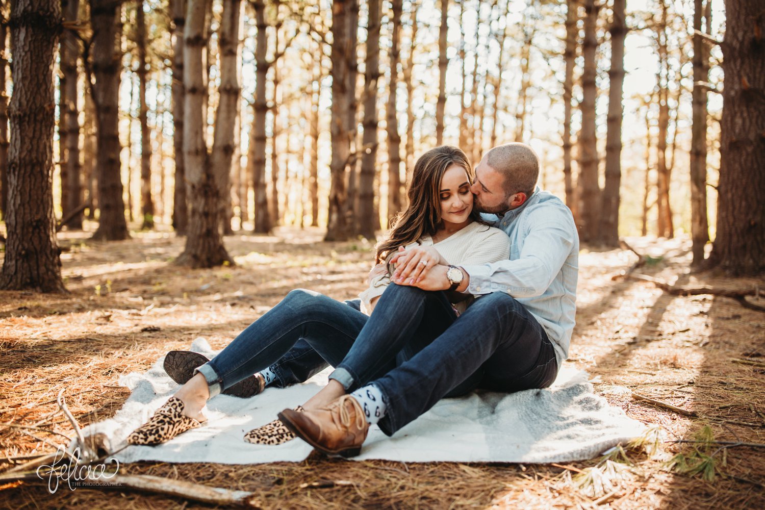 images by feliciathephotographer.com | The Forest | engagement photos | wedding photographer | engagement photographer | forest | sunrise | sitting down | blanket | cheetah print | shoes | brown | kc socks | kissing | smiling | 