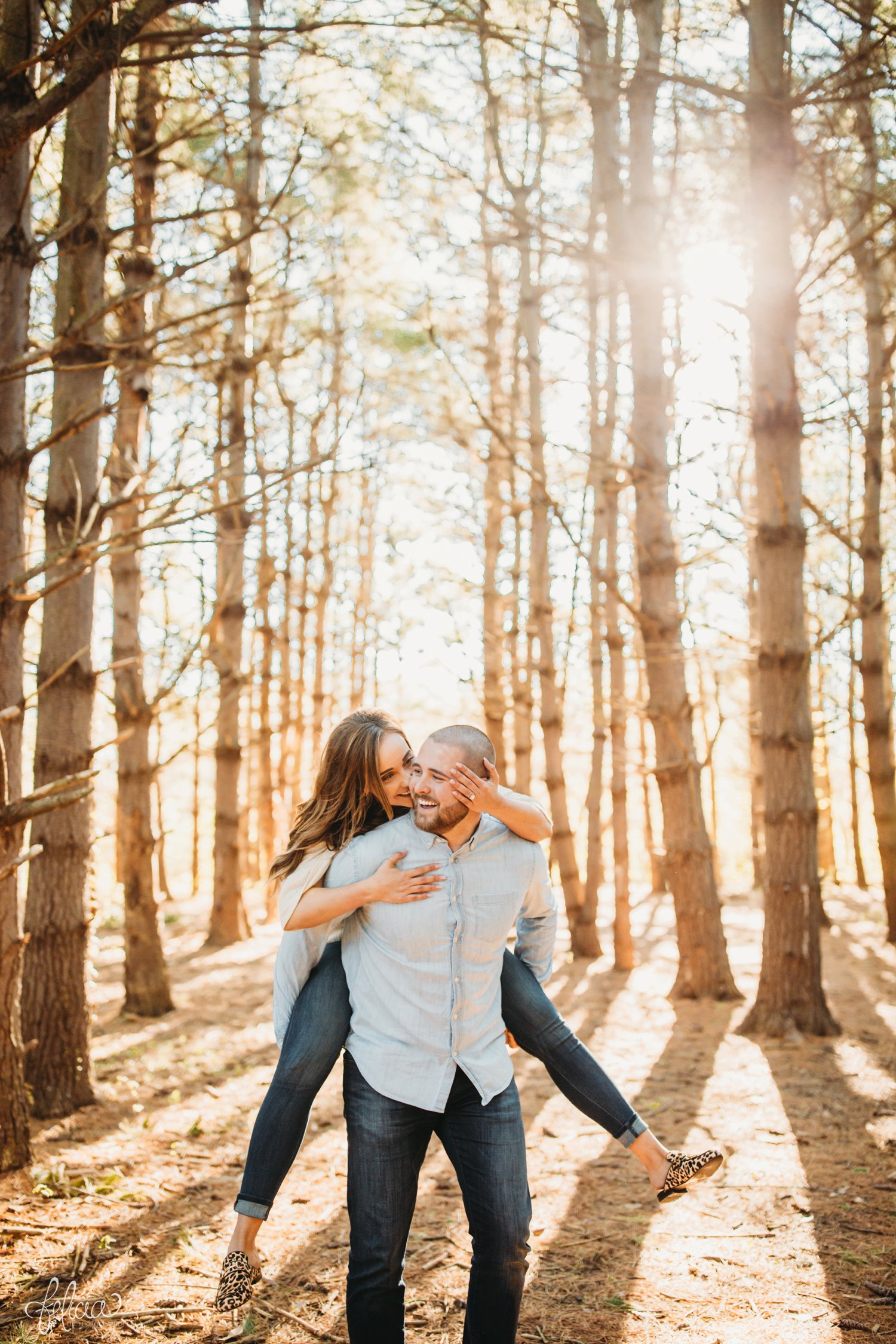 images by feliciathephotographer.com | The Forest | engagement photos | wedding photographer | engagement photographer | forest | sunrise | piggy back ride | tall trees | smiling | candid | posing | posed | wedding ring | cheetah print shoes | blue jeans | love | happy | 