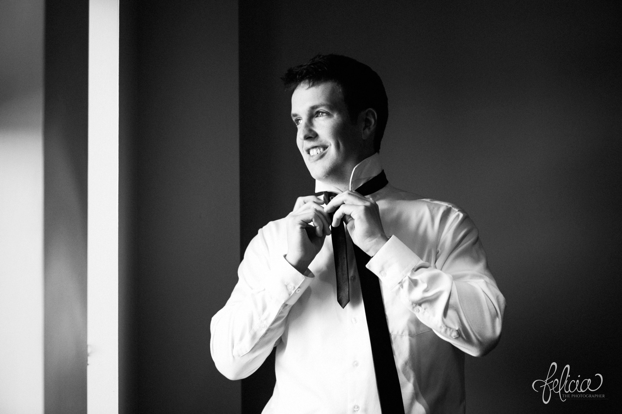 black and white | weddings | wedding photos | wedding photography | images by feliciathephotographer.com | St. Therese Catholic Church | Kansas City | downtown | The Terrace on Grand | wedding prep | getting ready | groom solo shot | groom getting ready | black tie | candid 