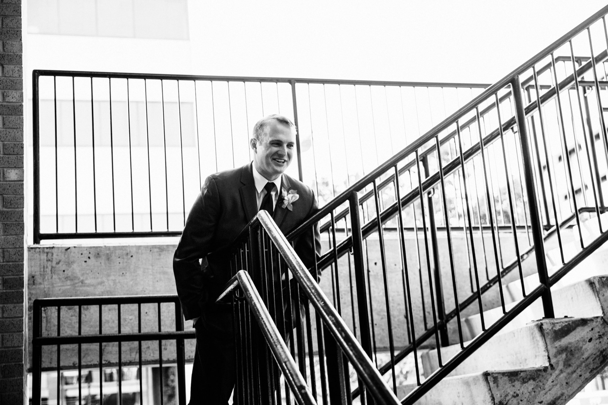 black and white | wedding | wedding photos | wedding photography | images by feliciathephotographer.com | Country Club Plaza | Kansas City | Unity Temple | first look | groom solo shot | staircase meeting | groom reaction | 