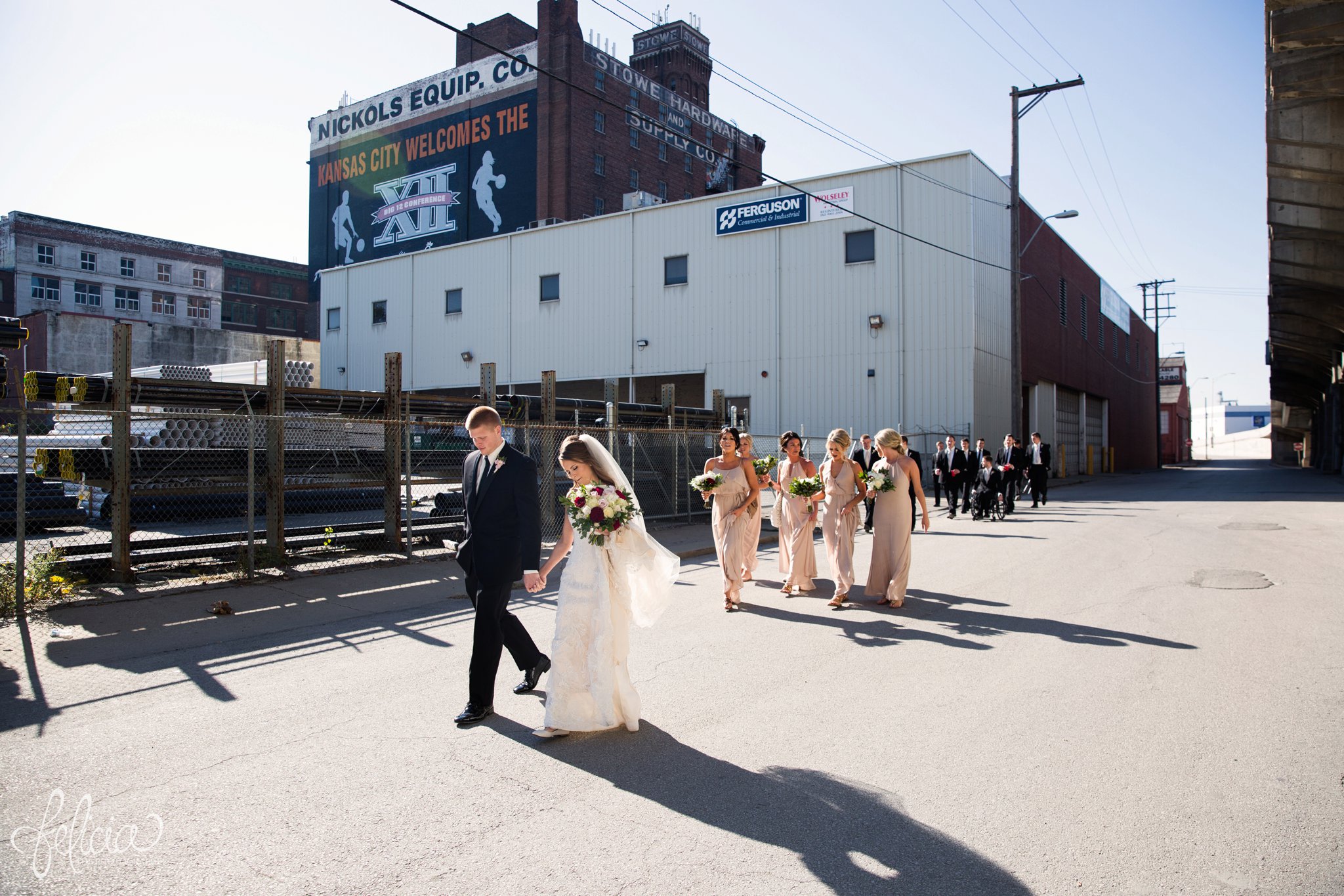 wedding | wedding photos | industrial | Rumely Event Space | wedding photography | images by feliciathephotographer.com | West Bottoms | industrial background | bridal party portraits | hand in hand | candid | walking