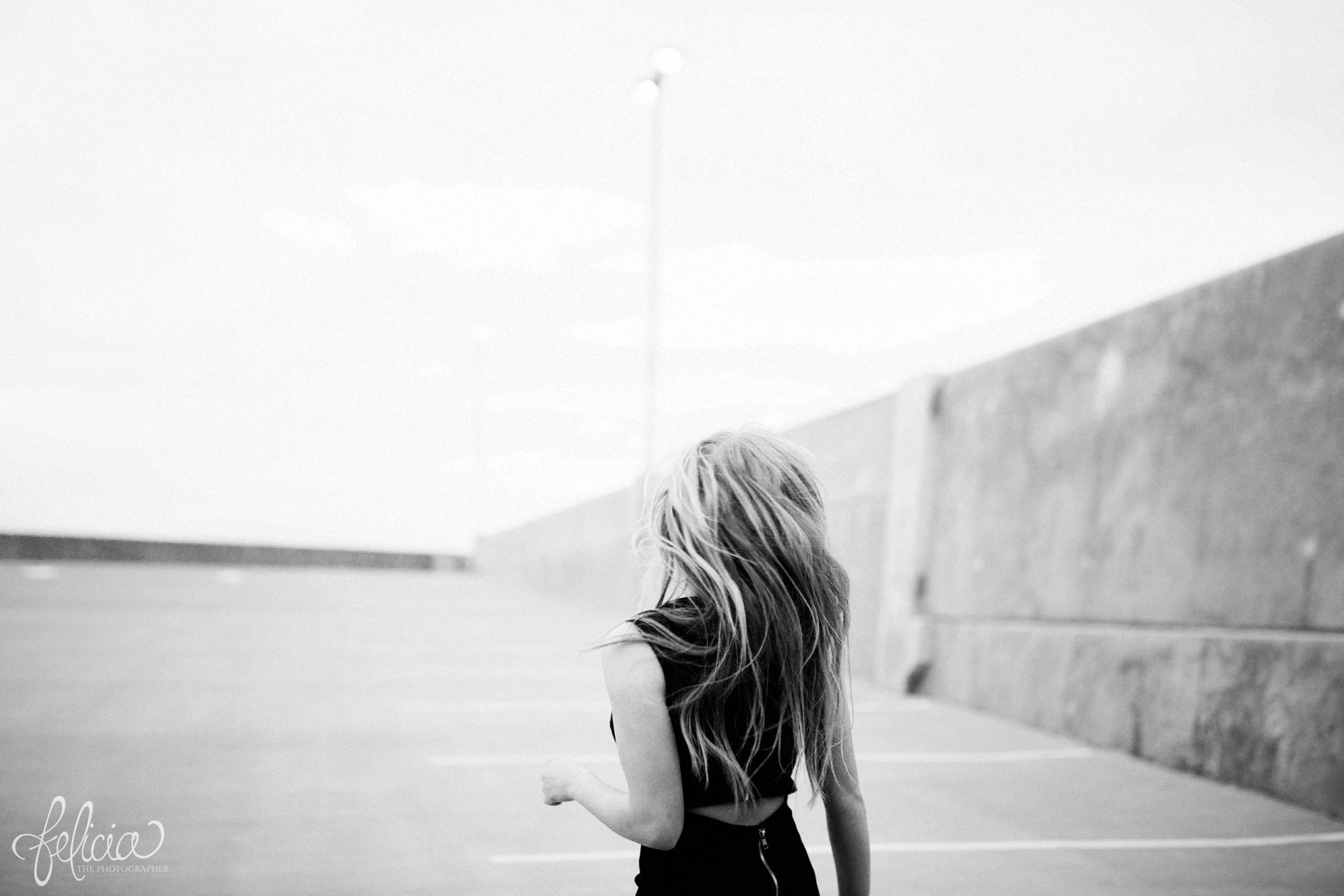 black and white | senior photos | senior photography | Lenexa | Kansas | images by feliciathephotographer.com | chic | dancer  | long blonde hair | hair flip | back to camera | pearl jewelry | pearl necklace | pearl earrings 