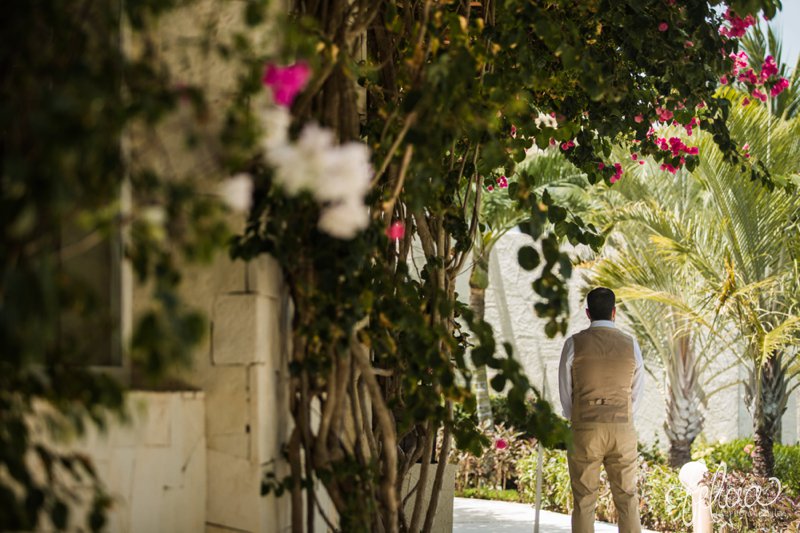 images by feliciathephotographer.com | Destination Beach Wedding | Mexico Resort | Photography | Azul Sensatori | First Look | Groom | Pink Floral | Palm Trees | Tropical Decor | Kaki Suit | Stone Wall | 