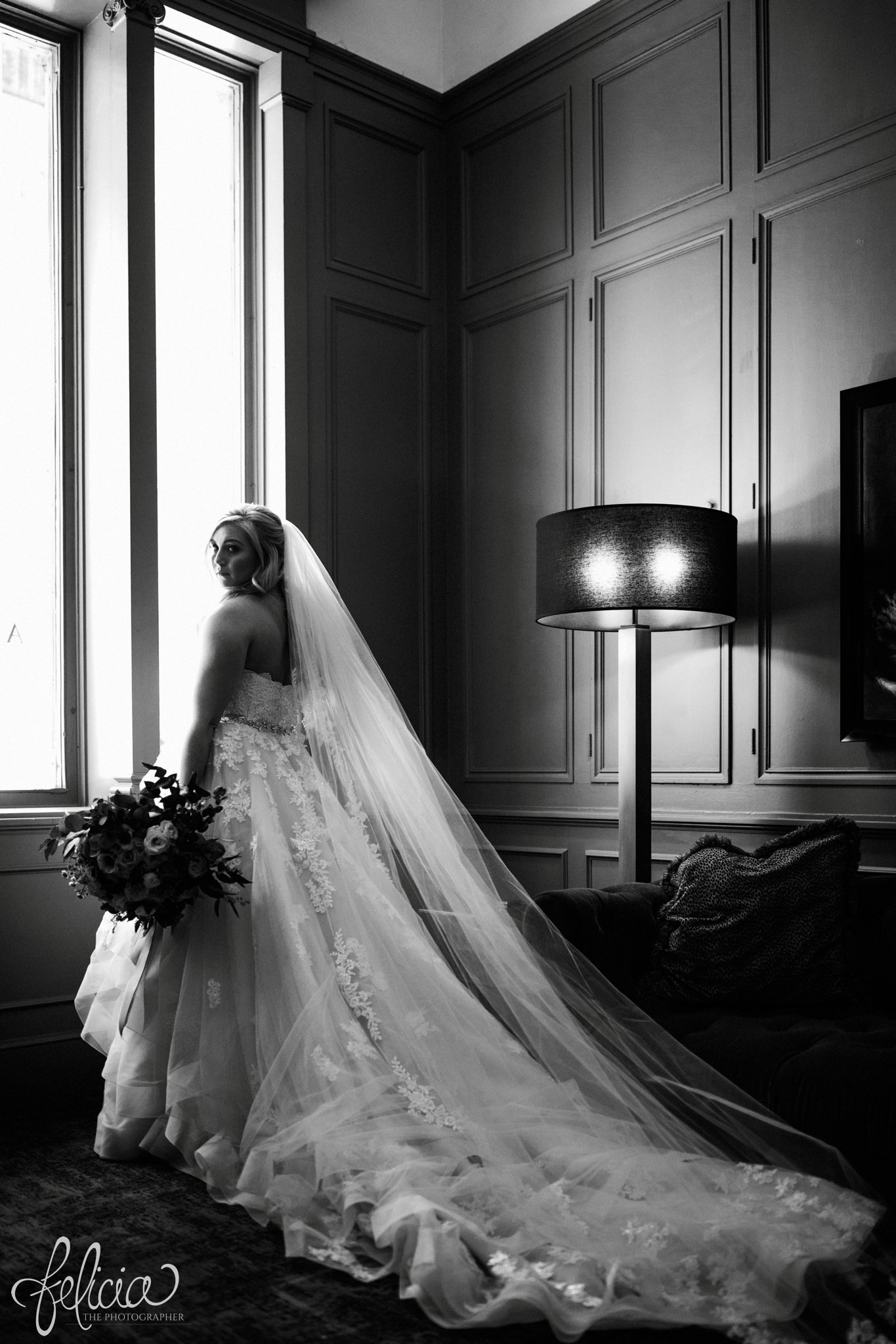 images by feliciathephotographer.com | wedding photographer | downtown kansas city | bridal portrait | long lace train | wild hill flowers | black and white | hotel ambassador | glamorous | belle vogue | 