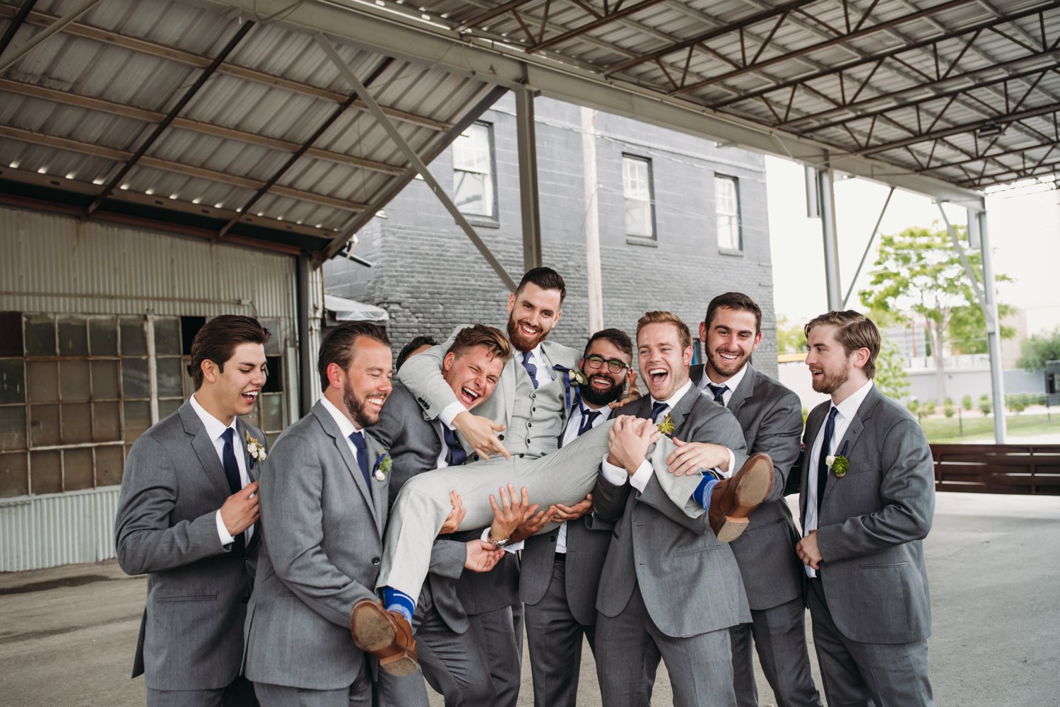  images by feliciathephotographer.com | destination wedding photographer | kansas city | spring time | groomsmen | silly | portraits | blue striped socks | grey suits | the black tux | navy tie | industrial | modern | 