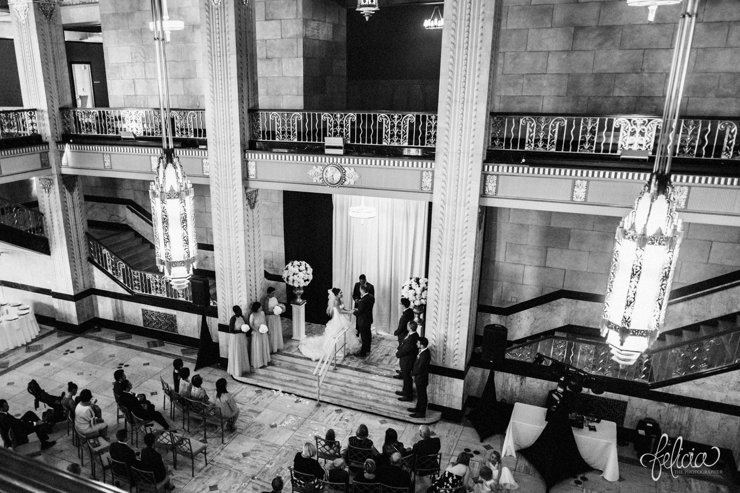 images by feliciathephotographer.com | destination wedding photographer | the grand hall at power and light | kansas city | missouri | downtown | glamorous | multicultural | ceremony | black and white | chandelier | venue | friends and family | joy | 