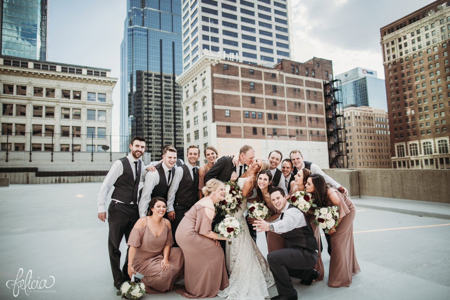 images by feliciathephotographer.com | destination wedding photographer | kansas city | best friends | laughter | natural light | mauve | light pink and red | bella bridesmaids | lace gown | fabulous frocks | full dramatic florals | wild hill | rooftop | urban | groomsmen | grey suit | tip top tux | 