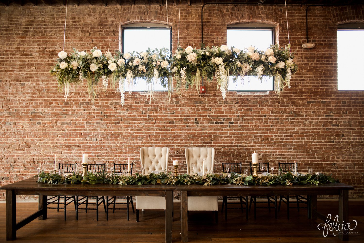 images by feliciathephotographer.com | magnolia venue | urban garden wedding | photographer | kansas city missouri | exposed brick | hanging bouquets | head table | candles | centerpieces | botanical floral design | 