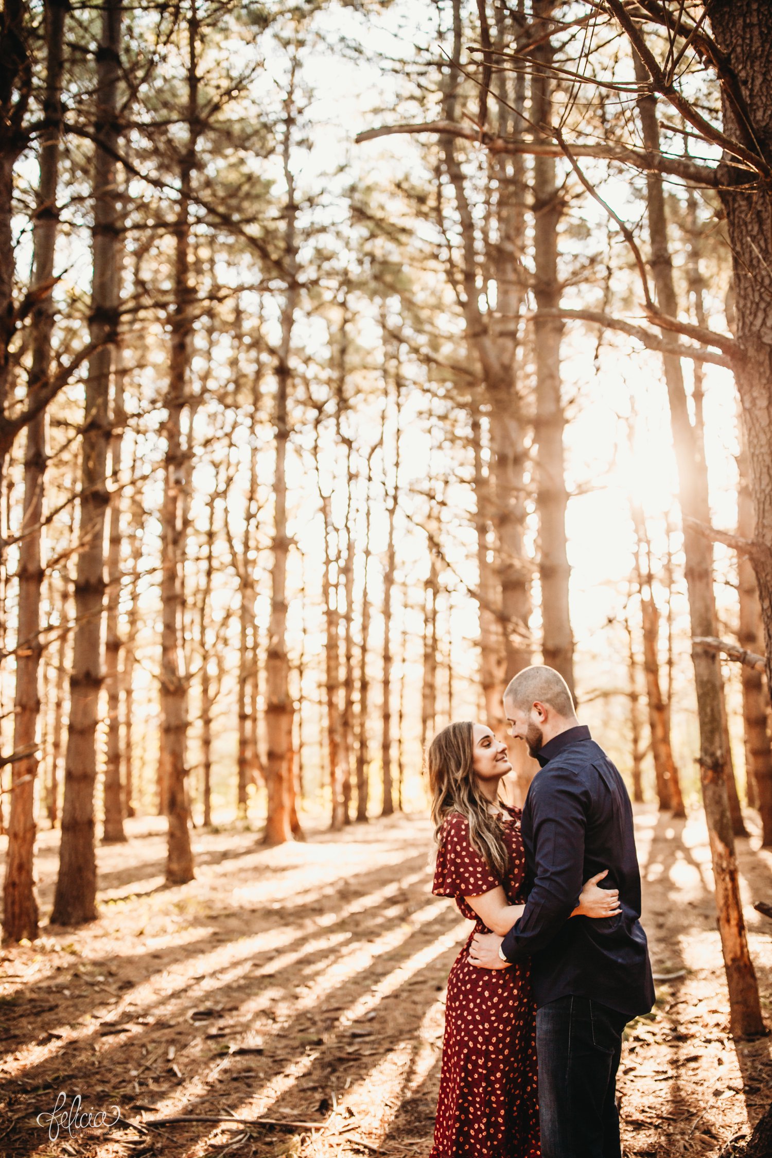 images by feliciathephotographer.com | The Forest | engagement photos | wedding photographer | engagement photographer | forest | sunrise | posed | posing | tall trees | floral dress | blue jeans | 